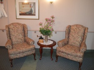 Sitting area with two large floral chairs in the Maples Home for Seniors 