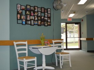 Lobby of Marmora retirement home with two chairs and framed images 