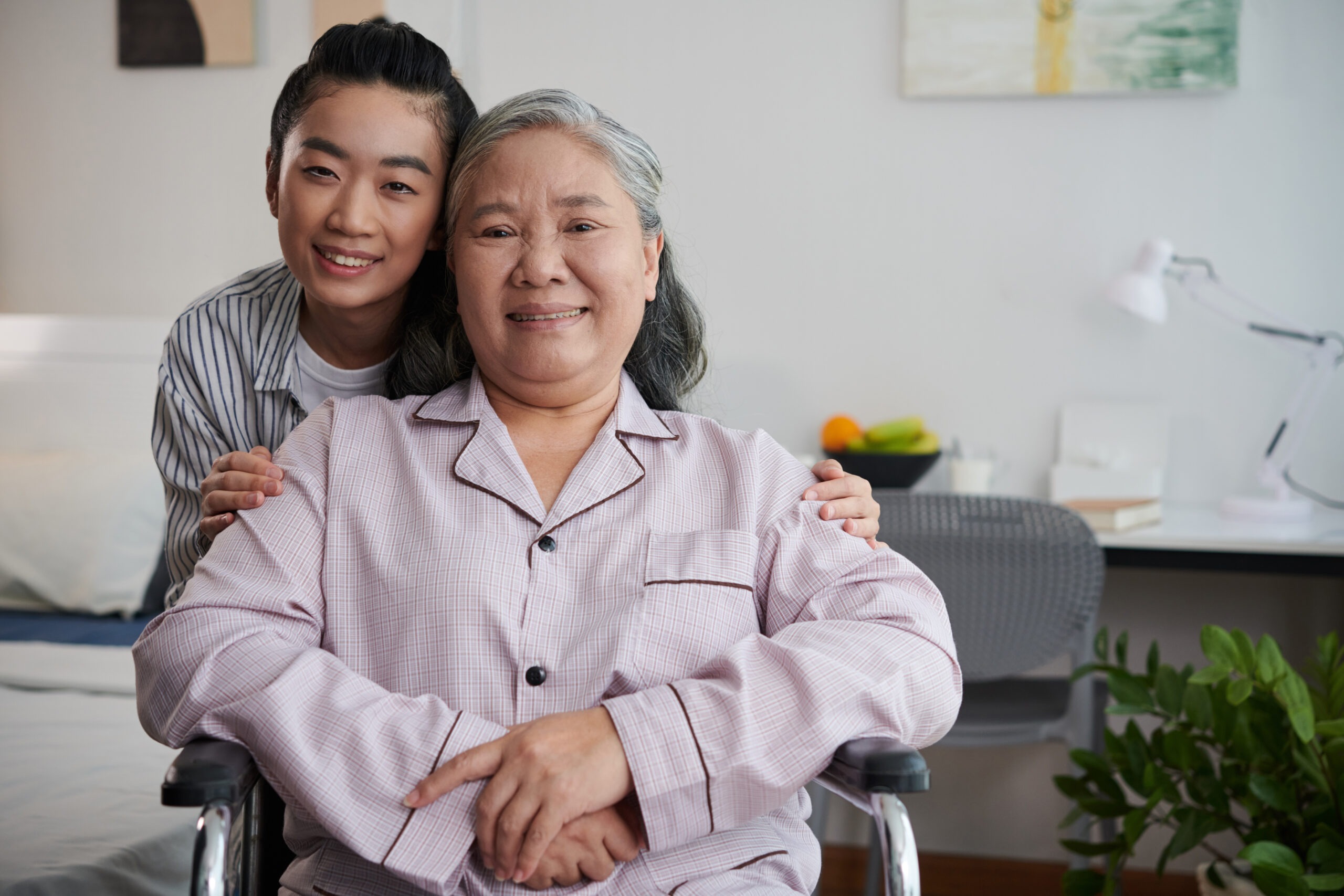 young woman hugging senior mother